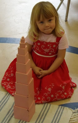 A child building pink tower